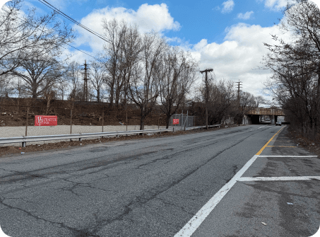 N Conduit Ave westbound, approaching the underpass near Lot B